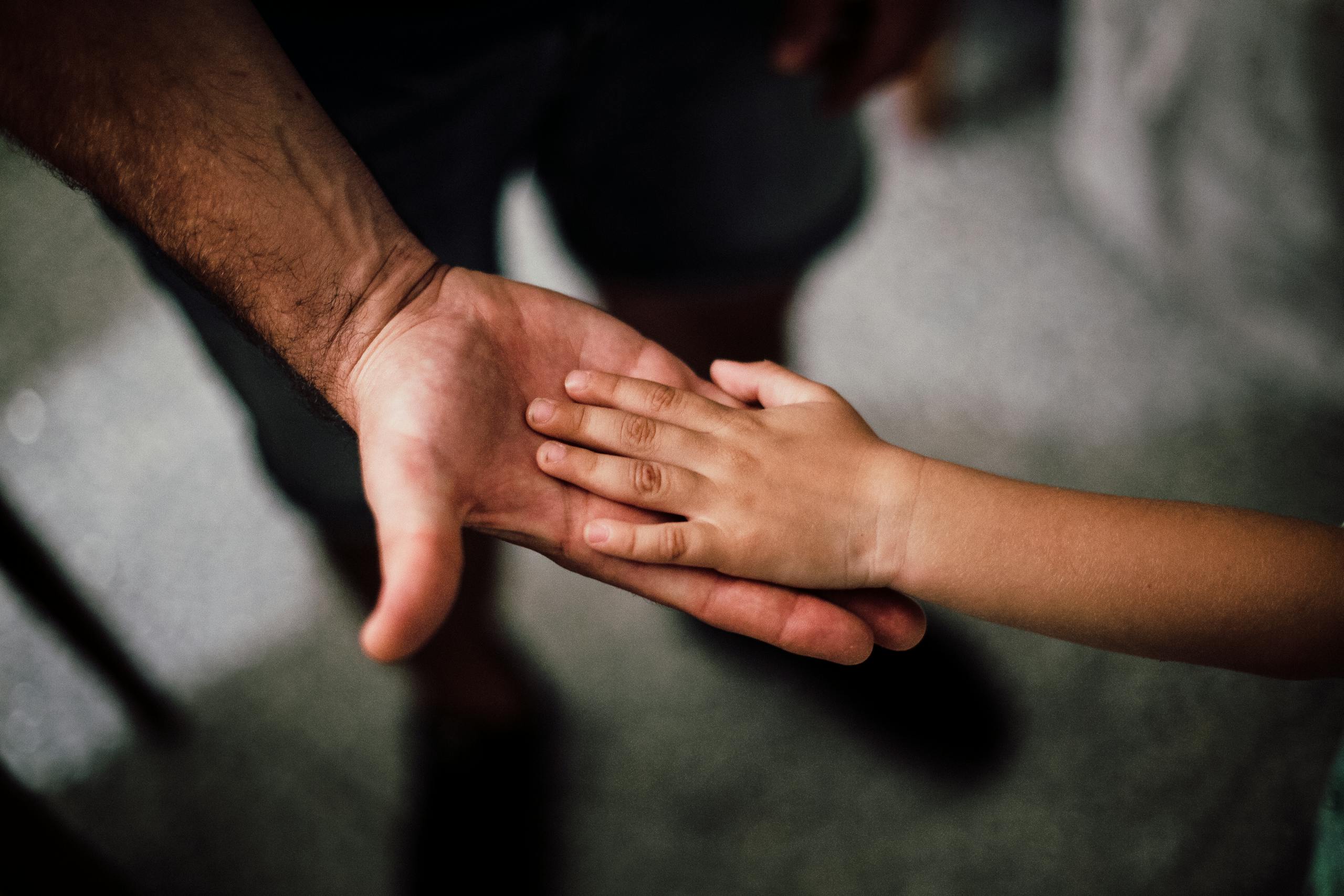 Father and Child's Hands Together